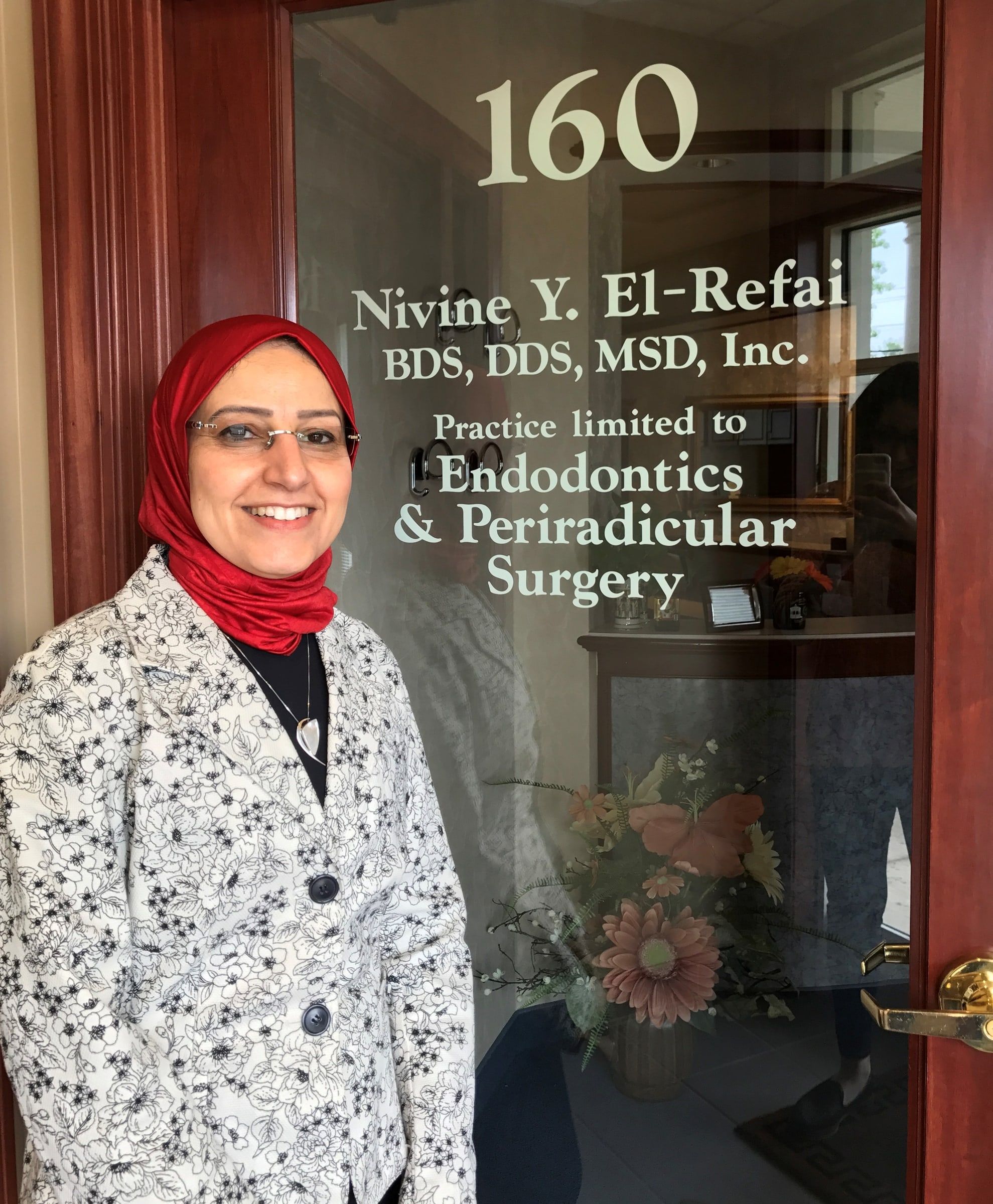 Dr. El-Refai at the door of Suite 160, lettered Practice limited to Endodontics and Periradicular Surgery